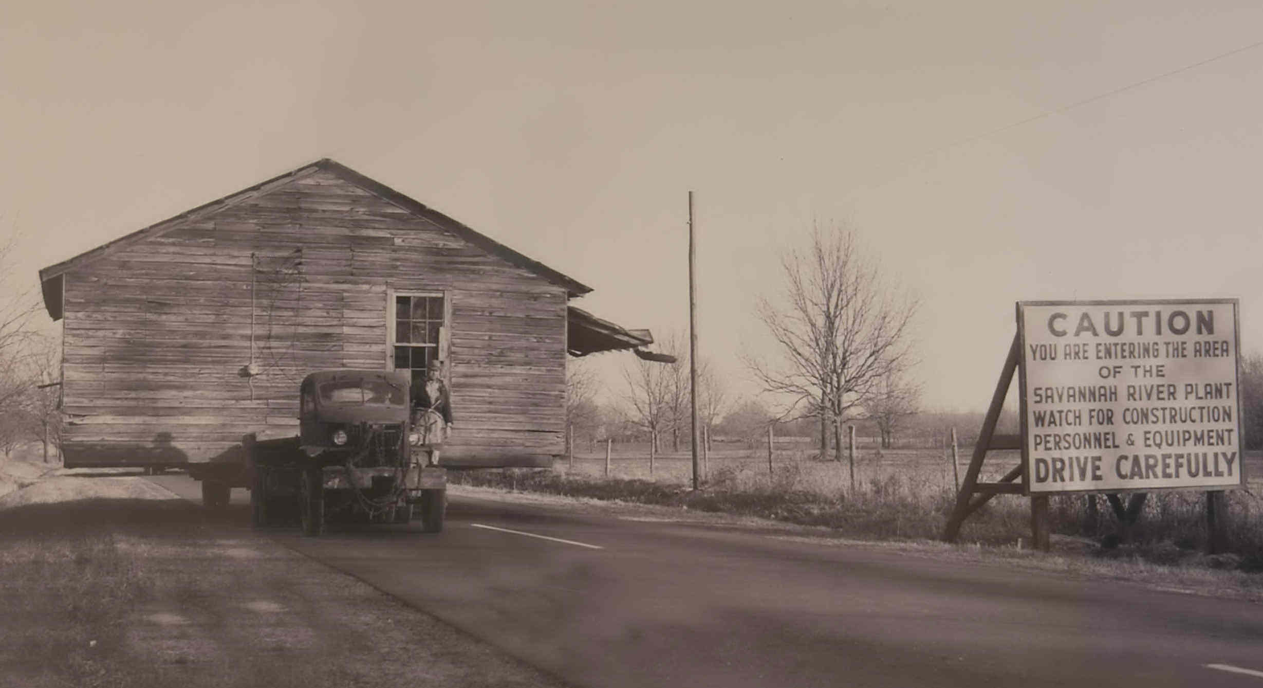 House being moved from site (circa 1951) to make way for construction of SRS facilities. Empty fields are now filled with pine trees planted by U. S. Forestry Service.
