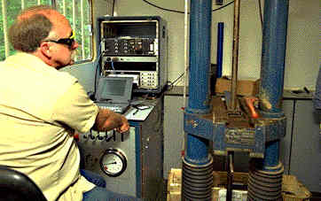 Inside a cone penetrometer truck, the hydraulic system and cone rod can be seen.