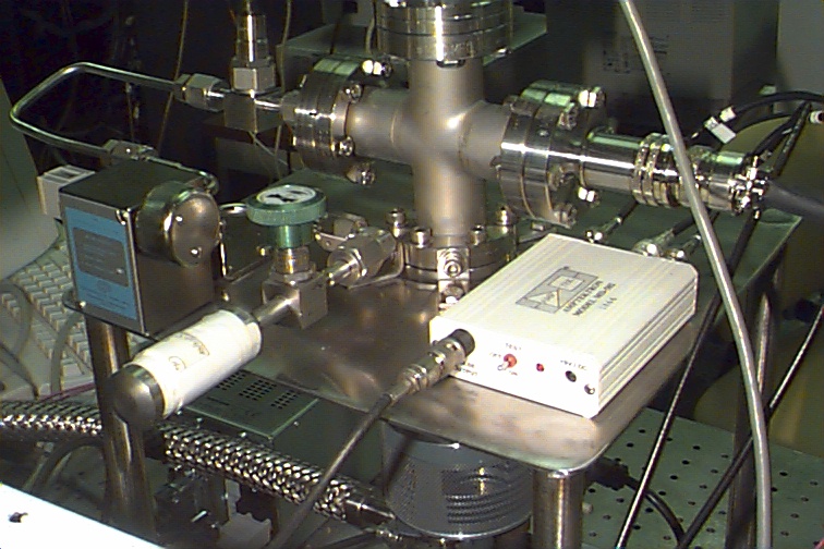 Figure 11. Close-up of an attached sample and the miniature ion trap with Amptek pulse counting detector. An ORTEC multichannel scalar card was used to count pulses.