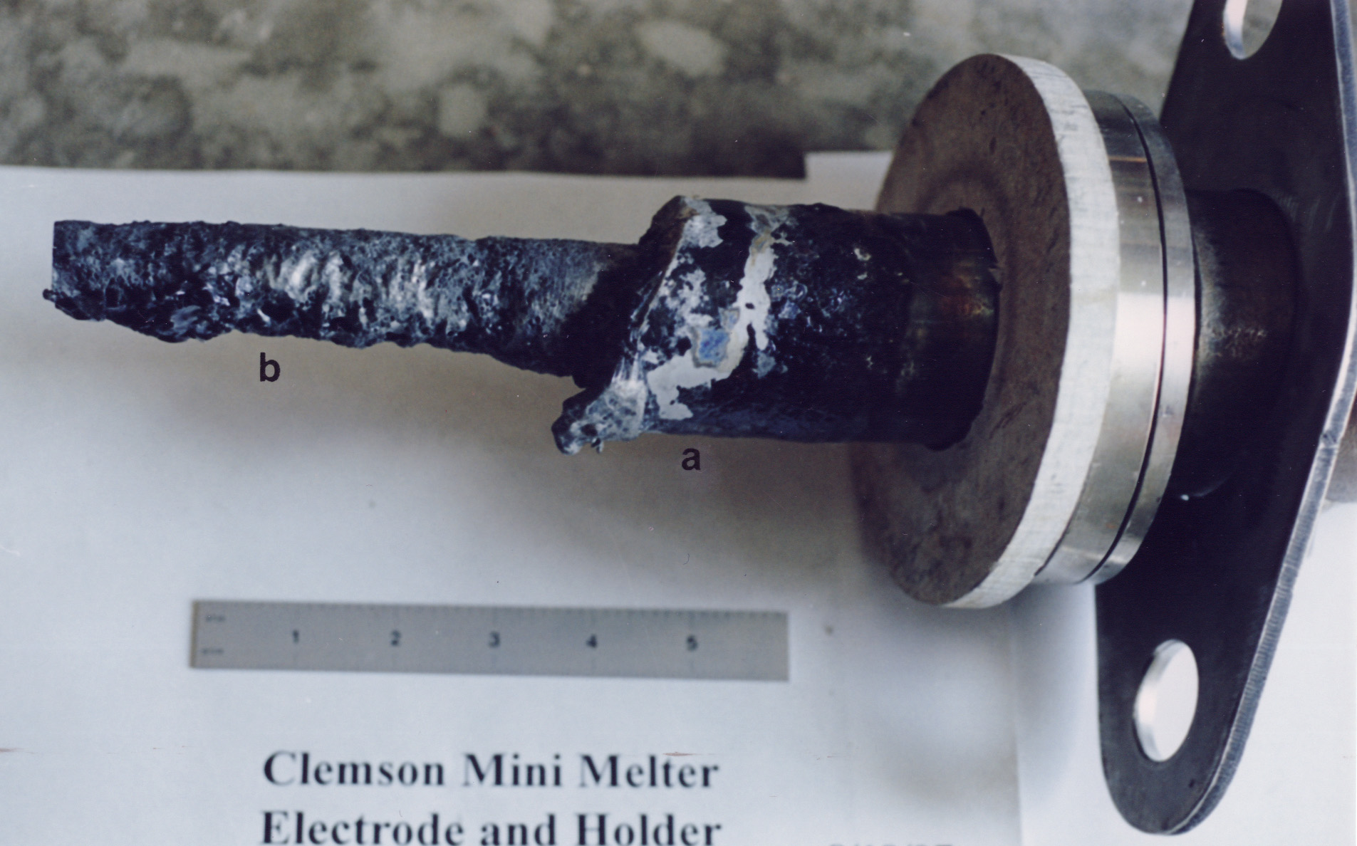Figure 2. Melter electrode assembly. a) 690 sheath, and b) molybdenum electrode